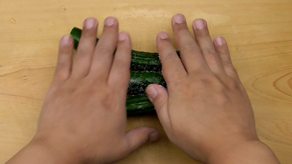 Grinding cucumber on a board